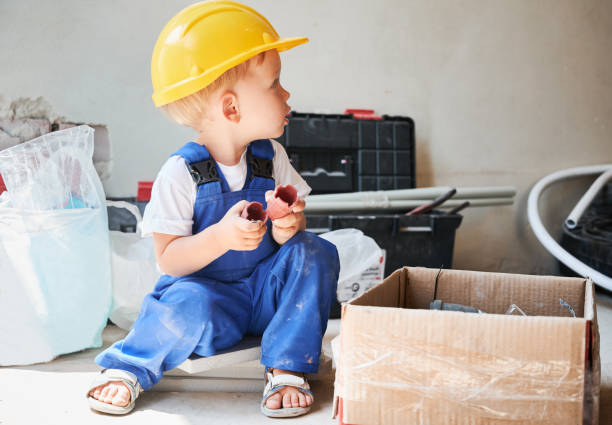 istock Adorable child sitting by the box with construction tools. 1459407650
