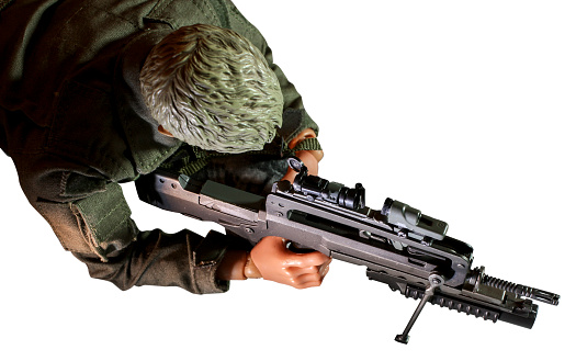 Scale model toy of an army men laying down aiming his target with a sniper rifle