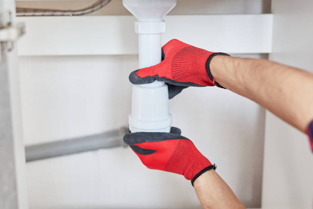 istock Professional plumber installs siphon pipe or replace the kitchen sink drain on kitchen. Worker repairing sink in kitchen and fix water plumbing leaks. Cleaning clogged pipes is dirty or rusty at home. 1459409296