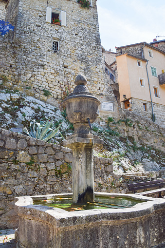 Peillon, France - August 30 2019: an old fountain in Peillon medieval village