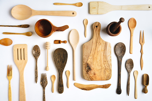 Wooden kitchen utensils on white background - knolling concept