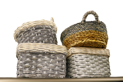 Stacked rustic baskets on shelf - viewing looking up - isolated on white