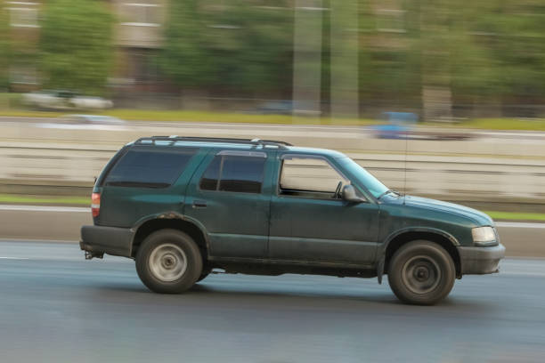 istock car driving fast down the street 1459413969