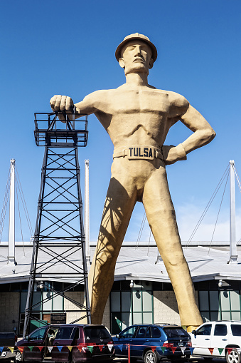 03-08-2018 Tulsa USA -The Golden Driller - Giant statue of oilman with bare muscles and a hardhat and a Tulsa belt buckle stands at fairground in Tulsa OK near Route 66
