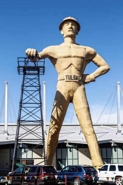 Giant statue of oilman with bare muscles and a hardhat and a Tulsa belt buckle stands at fairground in Tulsa OK near Route 66 03-08-2018 Tulsa USA -The Golden Driller - Giant statue of oilman with bare muscles and a hardhat and a Tulsa belt buckle stands at fairground in Tulsa OK near Route 66 tulsa landmark stock pictures, royalty-free photos & images