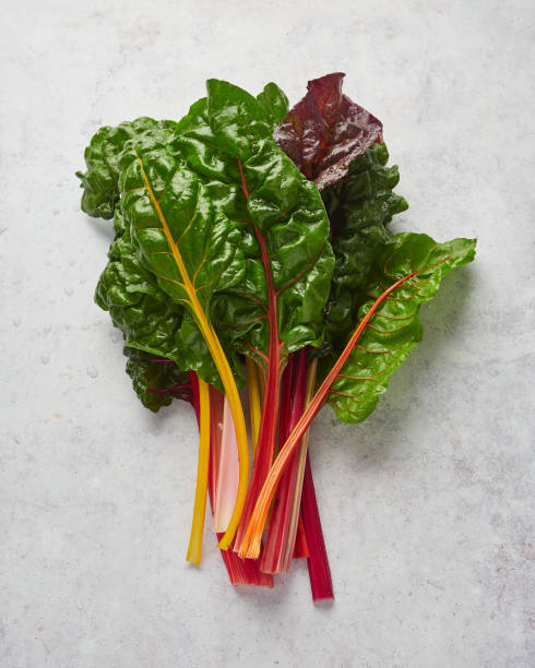 istock fresh leaves rainbow swiss chard isolated on grey stone 1459416341