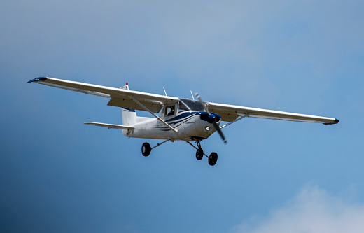 A small single prop airplane coming in for a landing at a local airport