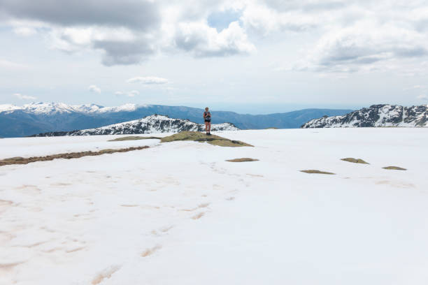 istock Hiking in spring-summer through snowy terrain 1459420401