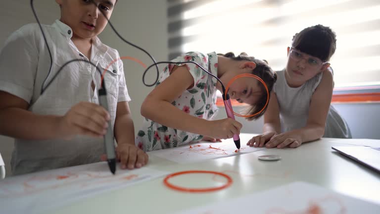 Children creating with 3D printing pen