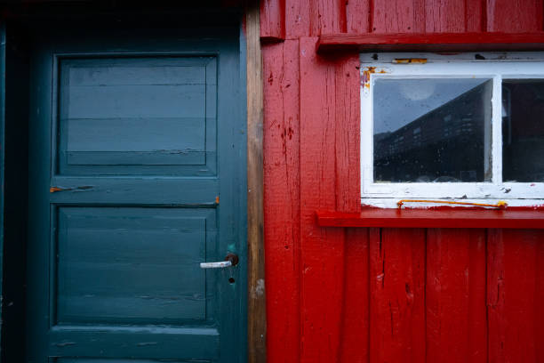istock Old wooden blue door and red wall with a small window.. 1459424805