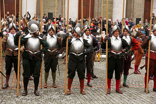 Geneva; Switzerland -Dec 11-12: Squad of foot soldiers armed with spears on the old square participate Escalade feast December 11-12, 2022 in Geneva, Switzerland.