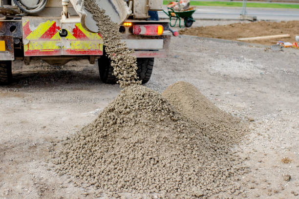 Concrete delivered to the construction site and discharged from the concrete mixing wagon truck Concrete delivered to the construction site and discharged from the concrete mixing wagon truck semi truck audio stock pictures, royalty-free photos & images