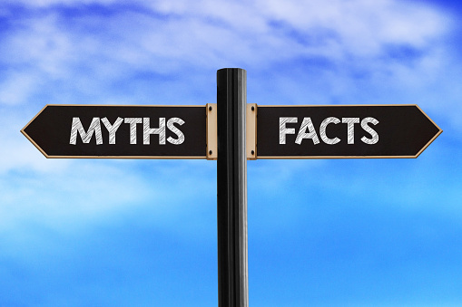 Myths and facts concept. Road sign with words myths and facts on sky background.