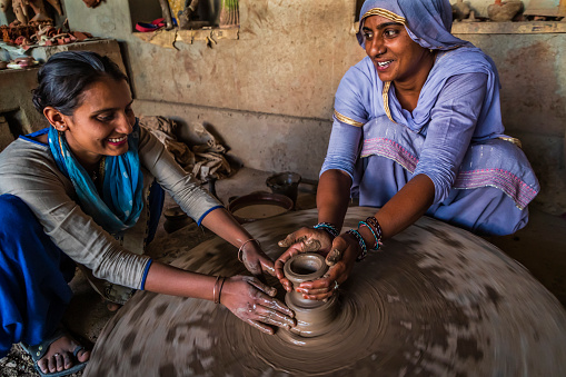 Indian potters working in a workshop, desert village in Rajasthan, India