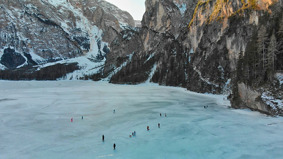 Braies Lake blotted in winter, aerial view from drone, Italian Alps.