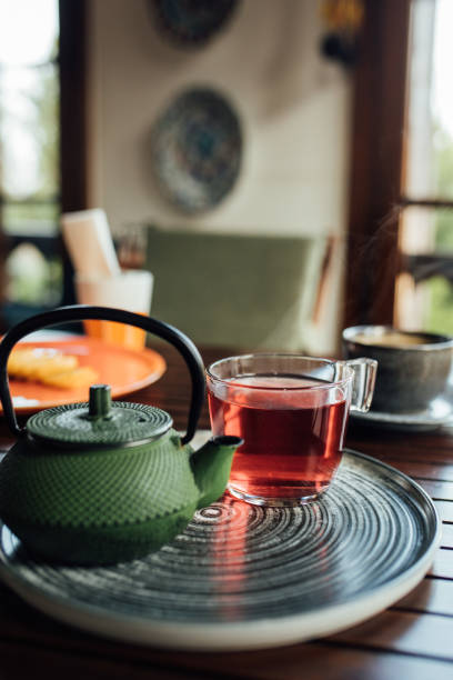 istock Iron teapot and a cup of herbal tea on table 1459436008