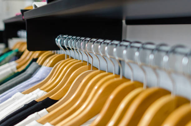 istock mens clothing apparel hanging on a rail. 1459436075