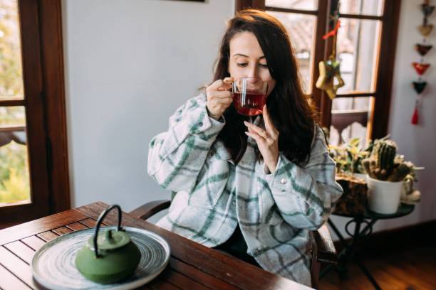 istock Woman drinking herbal tea for getting better health 1459436548