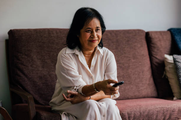 istock A Senior Woman Watching TV While Relaxing At Home 1459436715