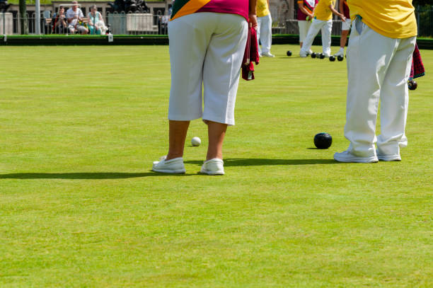 istock Lawn bowls, players stood over the Jack. 1459436748
