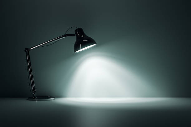 Front view on blank wall background with place for advertising text or poster illuminated by black table lamp in dark room. 3D rendering, mockup