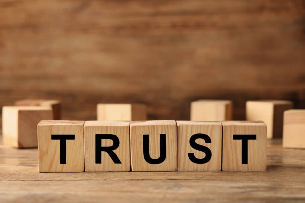 istock Cubes with word TRUST on wooden table. Space for text 1459443712