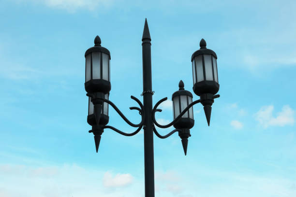 istock Old fashioned street light lamp against cloudy sky 1459443767