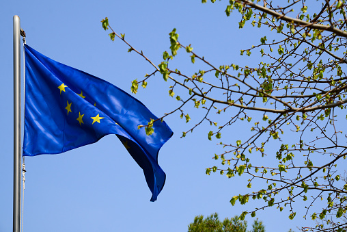European Union flag fluttering against blue sky