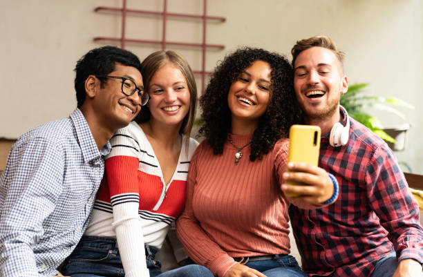 istock Young friends group making selfie with smartphone - Community concept with multicultural and multiethnic friends having fun video calling with friends - Diversity and friendship concept 1459445506
