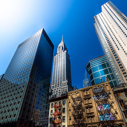 New York, USA - April 27, 2022: Beautiful and iconic Chrysler Building an Art Decostyle skyscraper surrounded by modern buildings