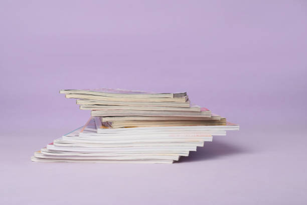 istock Group of stacked magazines on violet background 1459446391