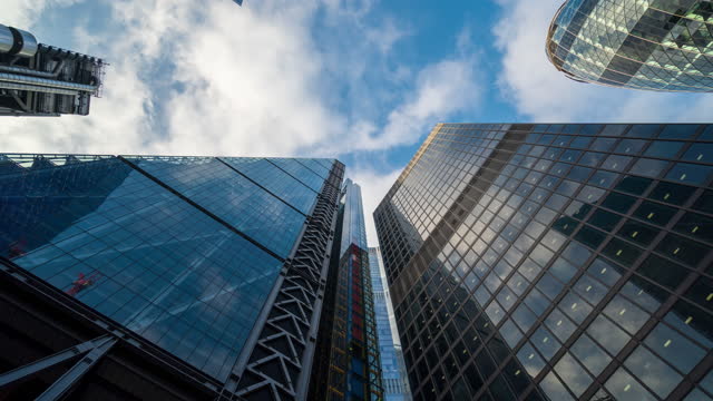Skyscraper in London Financial district with clouds in the daytime - 4k time-lapse (tilt-up)