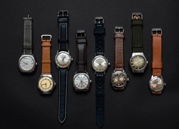 Group of vintage automatic and quartz watches on black background