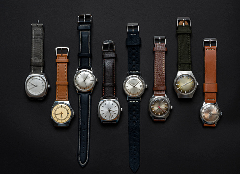 Group of vintage automatic and quartz watches on black background
