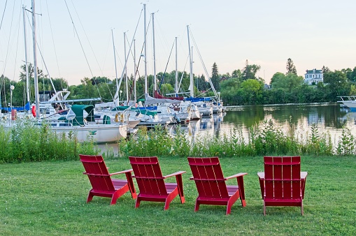 Superior Wisconsin USA, August 7, 2018. Adirondack lawn chairs at water's edge on Barker's island marina. A tourist resort and marina on the southwest end of Lake Superior in Superior Bay.