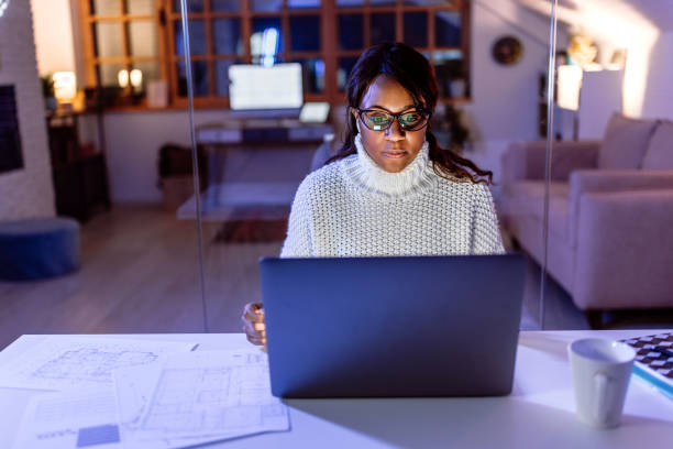 istock Woman doing papper work at home in the evening 1459451598