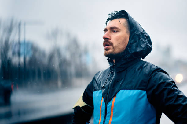 istock Exhausted athlete catching his breath in the rain. 1459453336