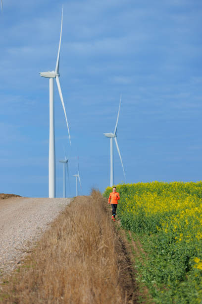 istock Running in agricultural area with wind turbines 1459456650
