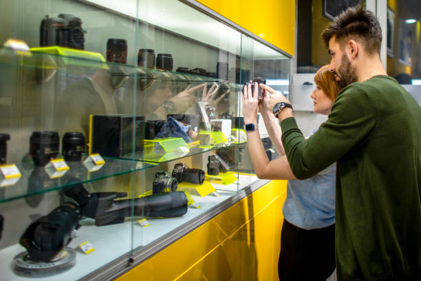 istock Young couple seen in a camera shop 1459456675