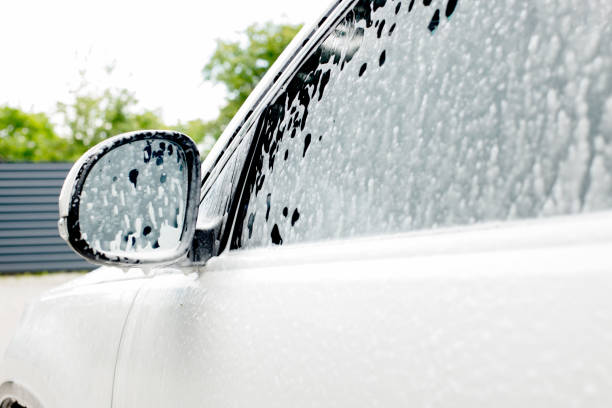 istock Washing mirrors in a white car with active foam. Car wash 1459460154