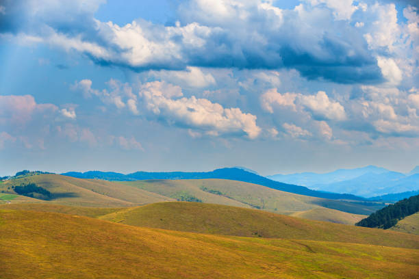 Blue cloudy sky above pasture hills and mount tops on Zlatibor in Serbia