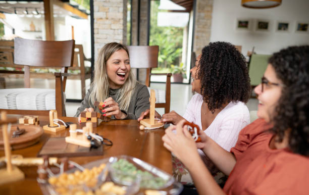 istock Friends laughing while solving wood puzzles together at home 1459470066