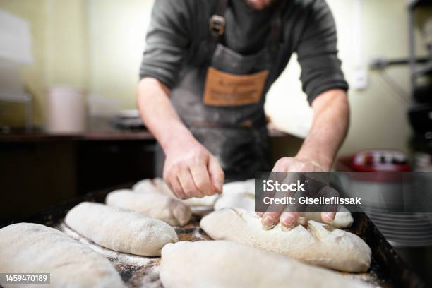 Baker Scoring Loaves Of Bread Before Baking Them In An Oven Stock Photo - Download Image Now