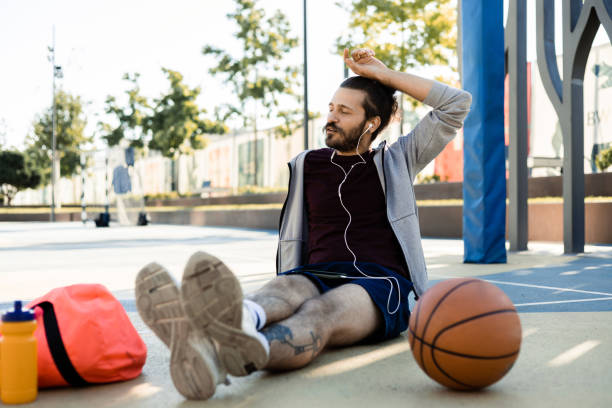istock Happy young man enjoying music after playing basket 1459471139