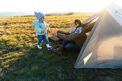 Family camping in nature with baby girl.