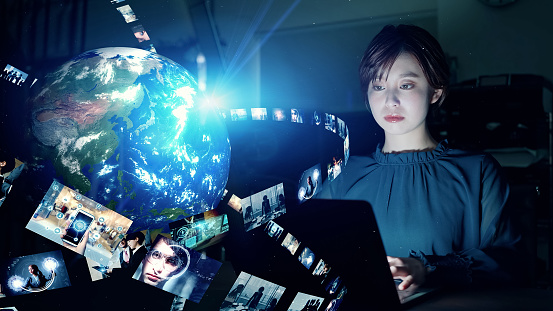 Young woman watching various screens. Communication network. Elements of this image furnished by NASA (url:https://earthobservatory.nasa.gov/blogs/elegantfigures/wp-content/uploads/sites/4/2011/10/land_shallow_topo_2011_8192.jpg)