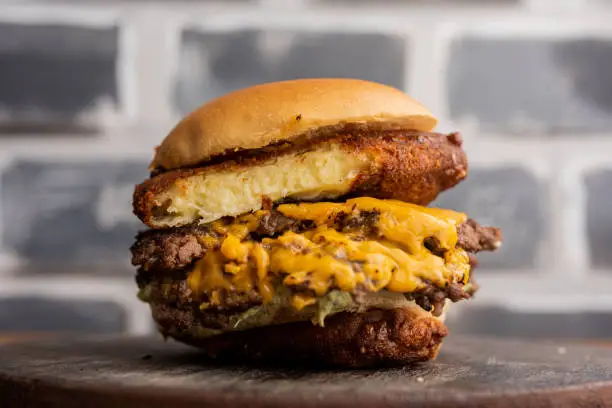 Photo of hamburger - beef sandwich with breaded mozzarella cheese, cheddar cheese and mayonnaise