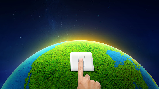 Human hand turning off the switch. Earth Hour Concept