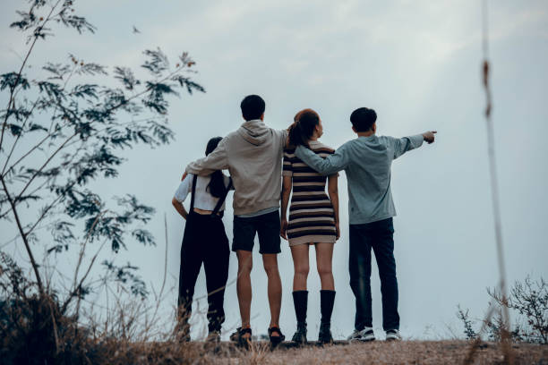 istock A group of friends looking at the sky together. 1459487682