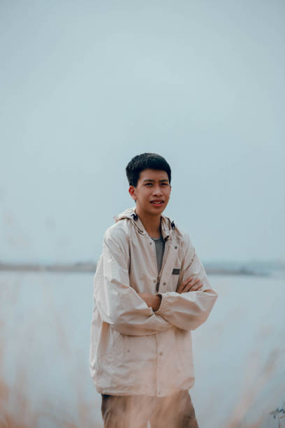 istock Asian man standing with his arms crossed looking at the camera 1459487720